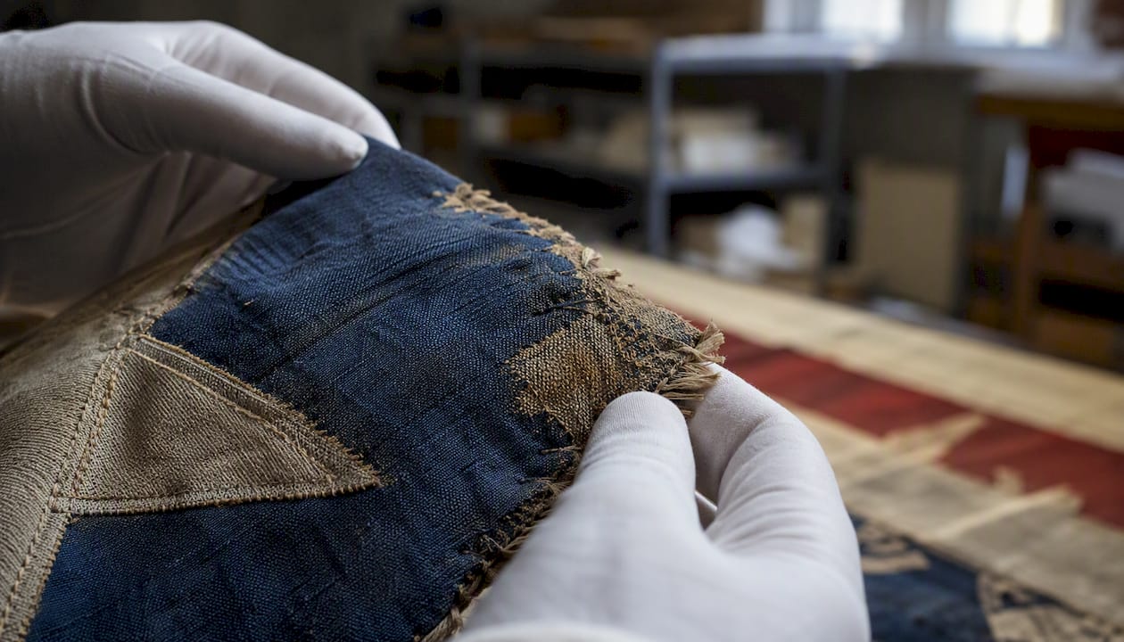 Close-up of historic flag fabric under examination