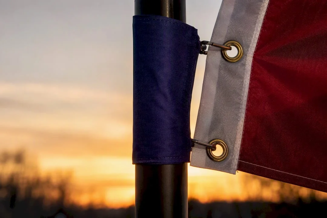 Flagpole sleeve and grommet hardware close-up