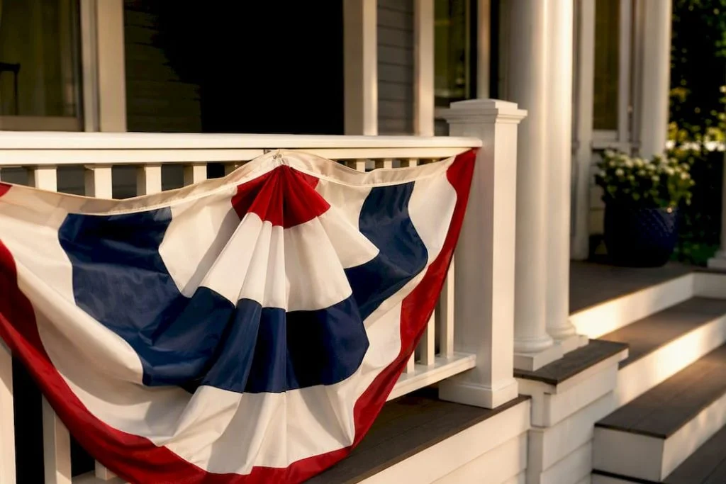 Patriotic bunting draped across porch railing