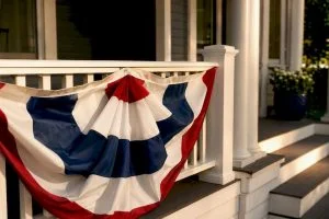 Patriotic bunting draped across porch railing