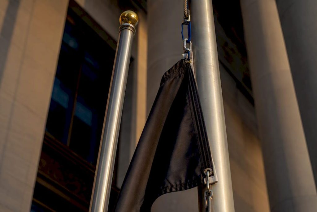 Partial POW/MIA flag beside ceremonial pole