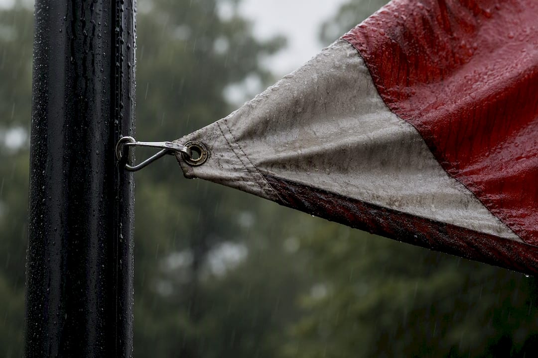 Flag fabric straining in heavy rain