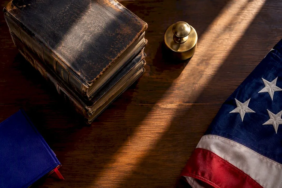 Historic flag fabric beside statute volumes