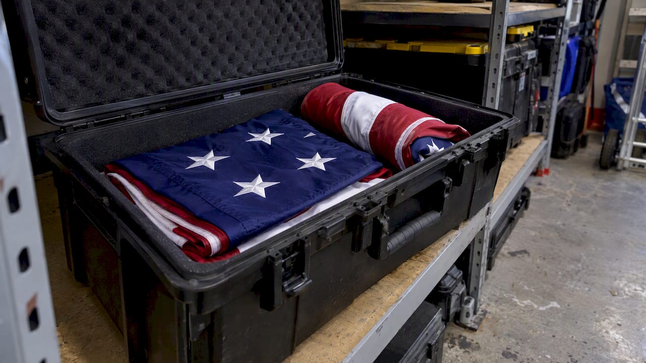 Folded flags stored inside a transport case
